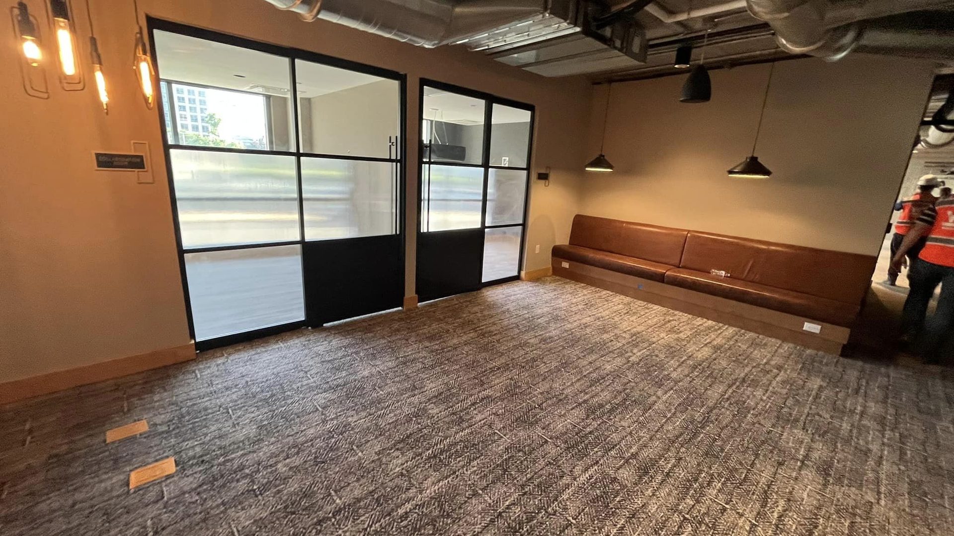 millwork_install_gurskyi_Office lounge with steel-framed glass partitions and built-in bench seating
